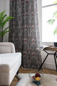 Detailed close-up of cotton linen curtains with vintage floral patterns and white fringe trim