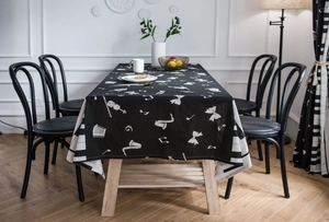 Detail of musical instrument print on black rectangular tablecloth with notes and violin