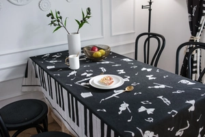Detailed close-up of piano keys and musical notes printed on black rectangular tablecloth