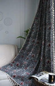 Close-up of vintage cotton linen curtain with floral pattern and tassel fringe detail