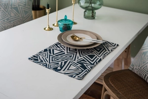 Close-up of navy blue geometric jacquard table runner with modern triangle pattern fabric