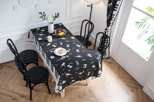 Close-up of piano key borders and musical instrument prints on a cotton blend tablecloth