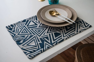 Close-up of navy blue and cream Nordic jacquard table runner with geometric triangle pattern