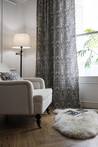 Detail of vintage floral cotton linen curtain with elegant fringe tassels and matching pillow
