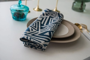 Macro detail of navy blue geometric jacquard fabric with woven triangle pattern textures