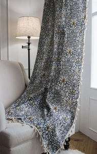 Detailed close-up of cotton linen curtain with vintage floral patterns and fringe edges