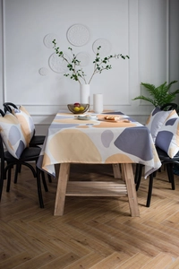 Detailed view of yellow geometric tablecloth texture and matching cushions