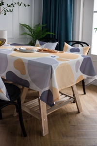 Detail of modern abstract pebble pattern tablecloth in yellow and grey fabric