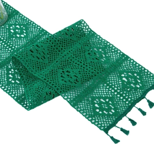 Green crochet lace table runner with geometric openwork and elegant tassel trim