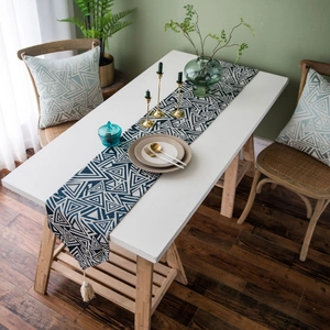 Nordic navy blue geometric triangle table runner with white tassels on white dining table