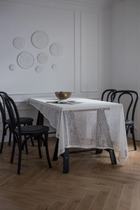 Detail of white lace tablecloth showing intricate hollow geometric diamond patterns
