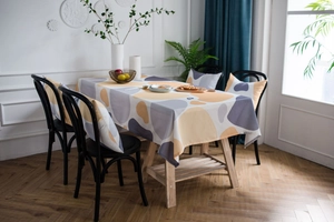 Detail of yellow and grey cobblestone print tablecloth with matching cushion covers