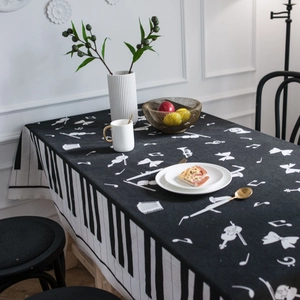 Artistic black rectangle tablecloth featuring piano keys and white musical motifs