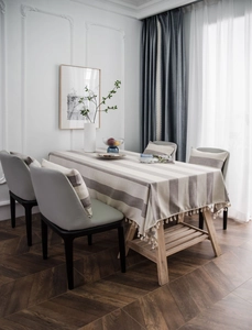 Detail of Nordic grey striped tablecloth with tassel edges and matching cushions