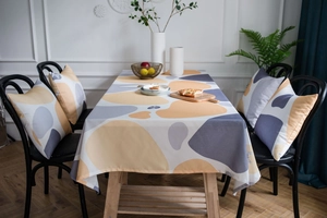Detailed texture of yellow cobblestone print linen tablecloth with modern drape
