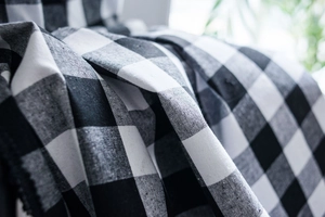 Macro detail of black and white buffalo plaid cotton linen fabric with soft texture