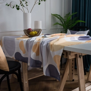 Modern abstract geometric tablecloth with yellow and orange pebble print for dining tables