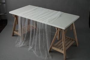 Close-up of elegant white mesh fabric with faux pearls for wedding table decoration
