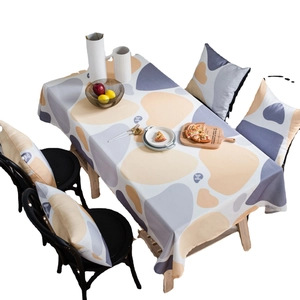 Rectangular pebble print tablecloth in yellow with matching chair cushions for home dining