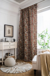 Detail view of Bohemian jacquard curtain fabric with colorful pom-pom fringe and geometric pattern