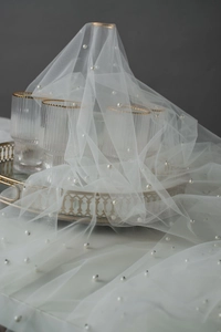 Detailed view of soft white pearl tulle mesh used for cake and dessert table photography