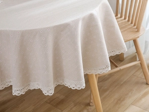 Detailed texture of Japanese cotton linen round tablecloth with daisy print and lace edge
