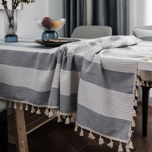 Nordic grey striped linen tablecloth with decorative tassels for a modern dining table