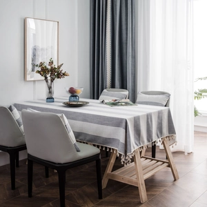 Modern grey and white striped linen tablecloth with decorative tassels for dining tables