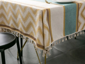 Close-up of chenille jacquard tablecloth with wave pattern and delicate fringe trim