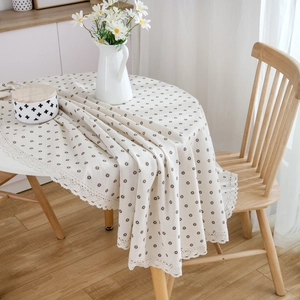 Japanese style daisy print tablecloth with lace edge on a round wooden dining table