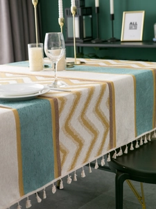 Detail of chenille jacquard tablecloth fabric featuring tassel edges and zigzag pattern