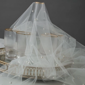 Elegant white pearl tulle fabric backdrop for photography and wedding table decor