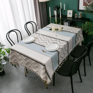 Detail of chenille jacquard tablecloth with geometric patterns and fringe edges