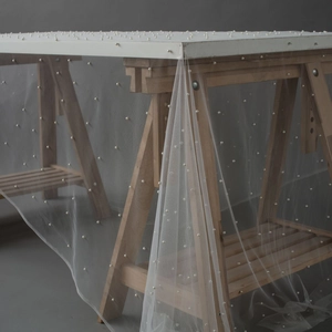 White semi-transparent mesh fabric with elegant pearl beads for photography backdrop