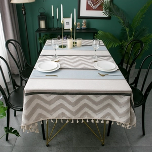 Detail of chenille jacquard tablecloth featuring chevron patterns and fringe tassels