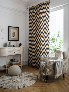 Detail of bohemian cotton linen curtain with black tassel fringe and golden wave pattern