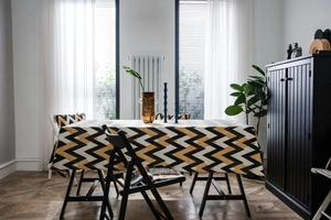 Detail of bohemian gold wavy chevron pattern tablecloth with glitter texture for home decor