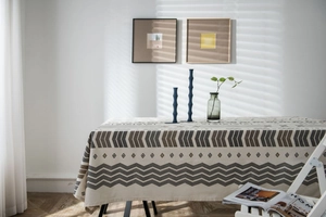 Detailed close-up of Bohemian cotton linen tablecloth with geometric patterns and natural sunlight