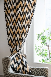 Detail showing black chevron printed cotton linen curtain with decorative fringe