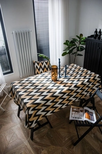 Detail of bohemian gold wavy patterned tablecloth with matching chair cushion set