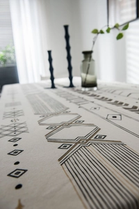 Detailed view of bohemian geometric patterns on high-quality linen blend tablecloth