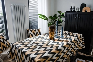 Close-up of golden wavy patterns on the high-quality tablecloth and cushion set