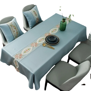Elegant misty blue rectangular tablecloth with floral embroidery and matching cushions