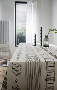 Detail of bohemian geometric print tablecloth in natural linen fabric with linen texture