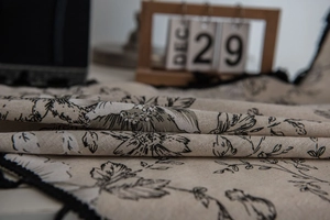 Detailed macro view of beige cotton linen fabric with vintage black rose floral printing