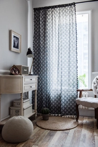 Detailed texture of cotton linen curtain with tree patterns and black tassels