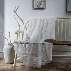 White vintage round lace tablecloth with floral hollow patterns and rustic lace edges