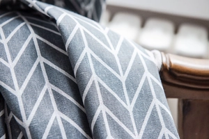 Close-up of gray geometric tassels and textured cotton linen weave on the window curtain