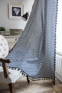 Detail of navy Japanese Seigaiha wave pattern fabric with black tassels on a chair