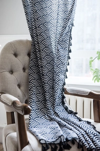 Detail of navy Japanese wave pattern curtain with cotton linen texture and fringe trim